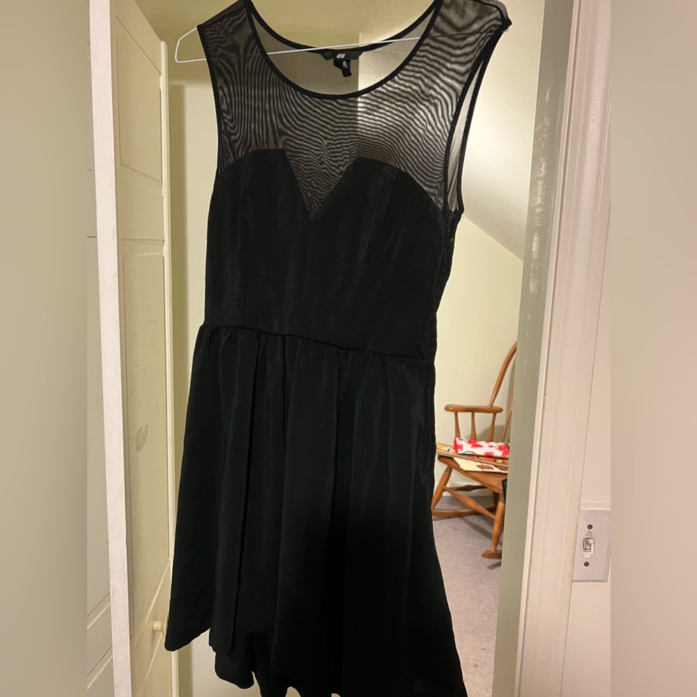 A simple black sheer mesh dress with a side zipper shorter in the front SZ 10